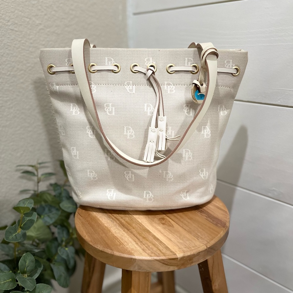 Dooney and bourke cream signature DB canvas jacquard/leather tassel bucket bag